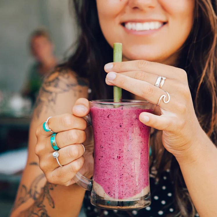 girl drinking berry smoothie